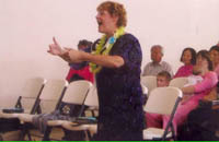 Claire conducts her choir at Trinity United Methodist