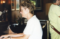 Claire playing the Koa Wood piano at Volcano House, Kilauea Crater, Big Island